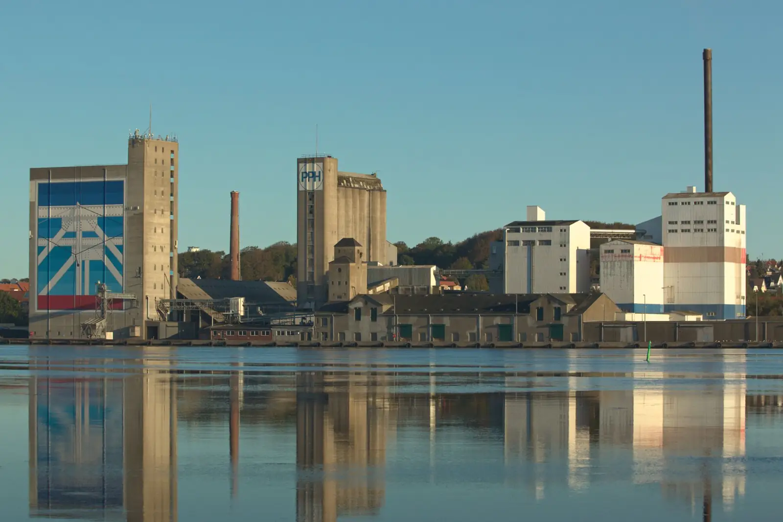 Industrial waterfront and silos reflected in Aalborg’s Limfjord