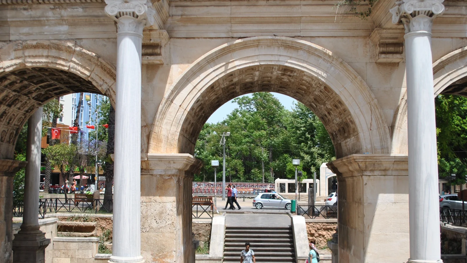 The central arch and flanking columns of Hadrian’s Gate in Antalya, with steps visible beyond.