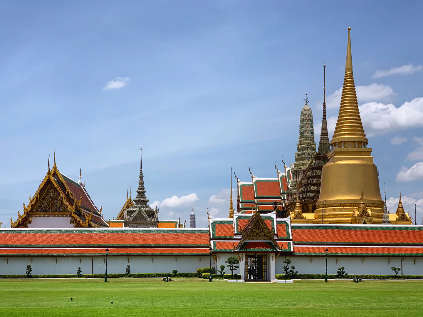 Gold spires and tiled roofs within Bangkok’s Grand Palace complex.