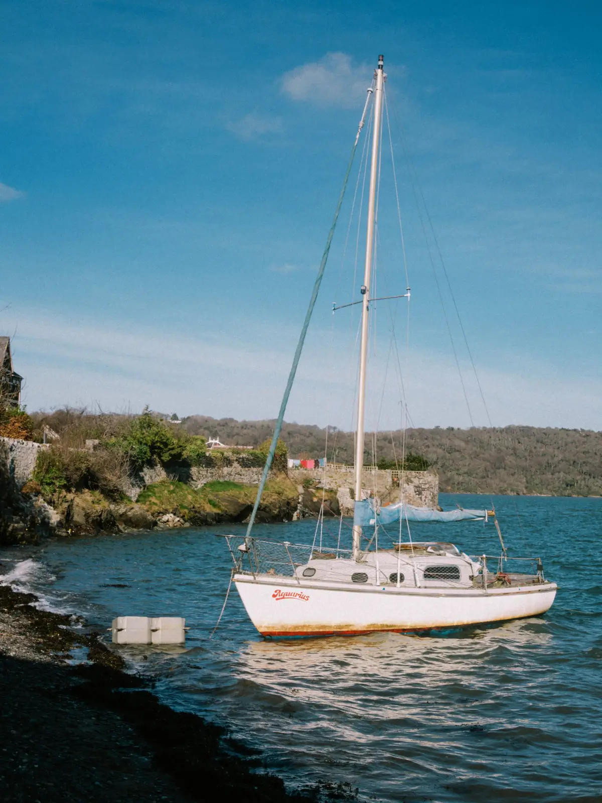A sailboat off the Bangor shoreline in Wales