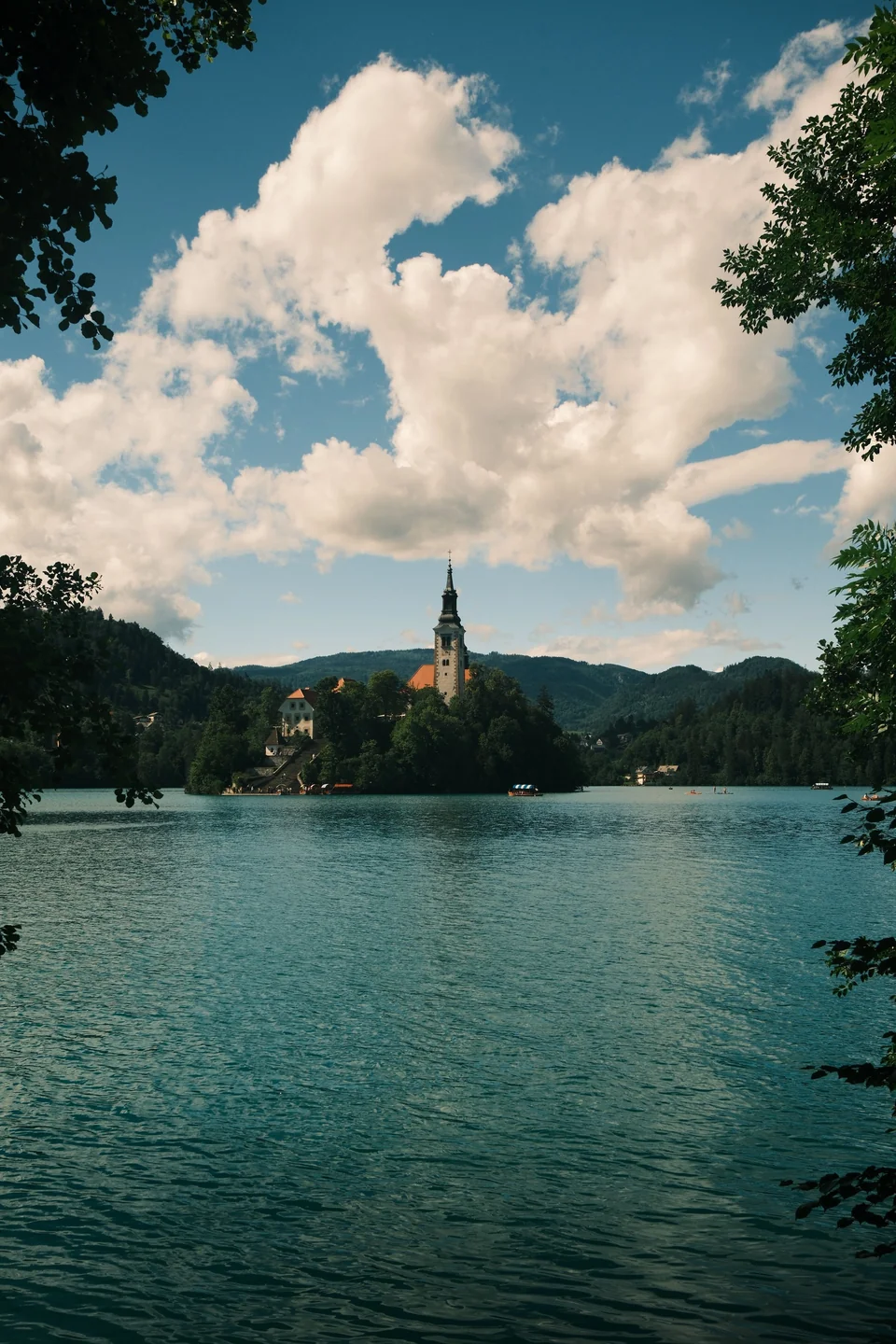 Bled Island’s church seen across the lake through a frame of trees