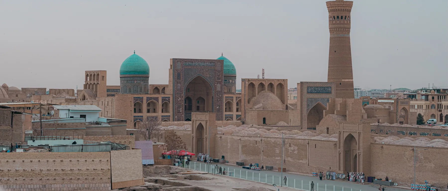 The Kalon Minaret and turquoise domes above the rooftops of Bukhara
