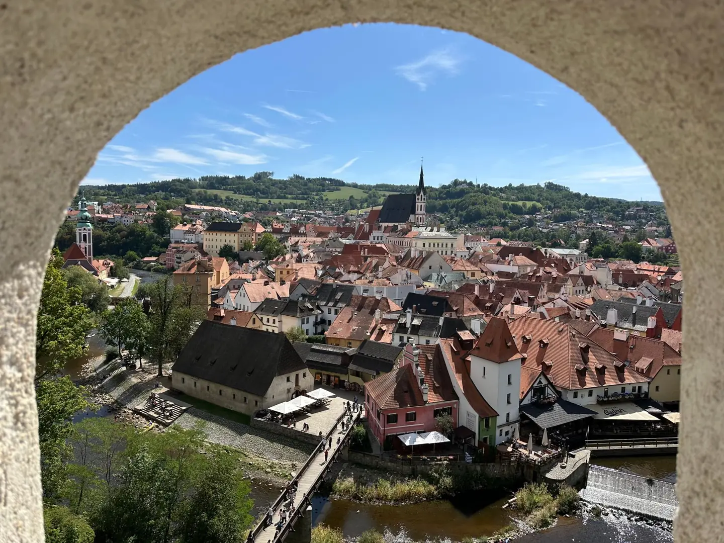Český Krumlov’s river bend and Saint Vitus Church framed by a Castle viewpoint opening