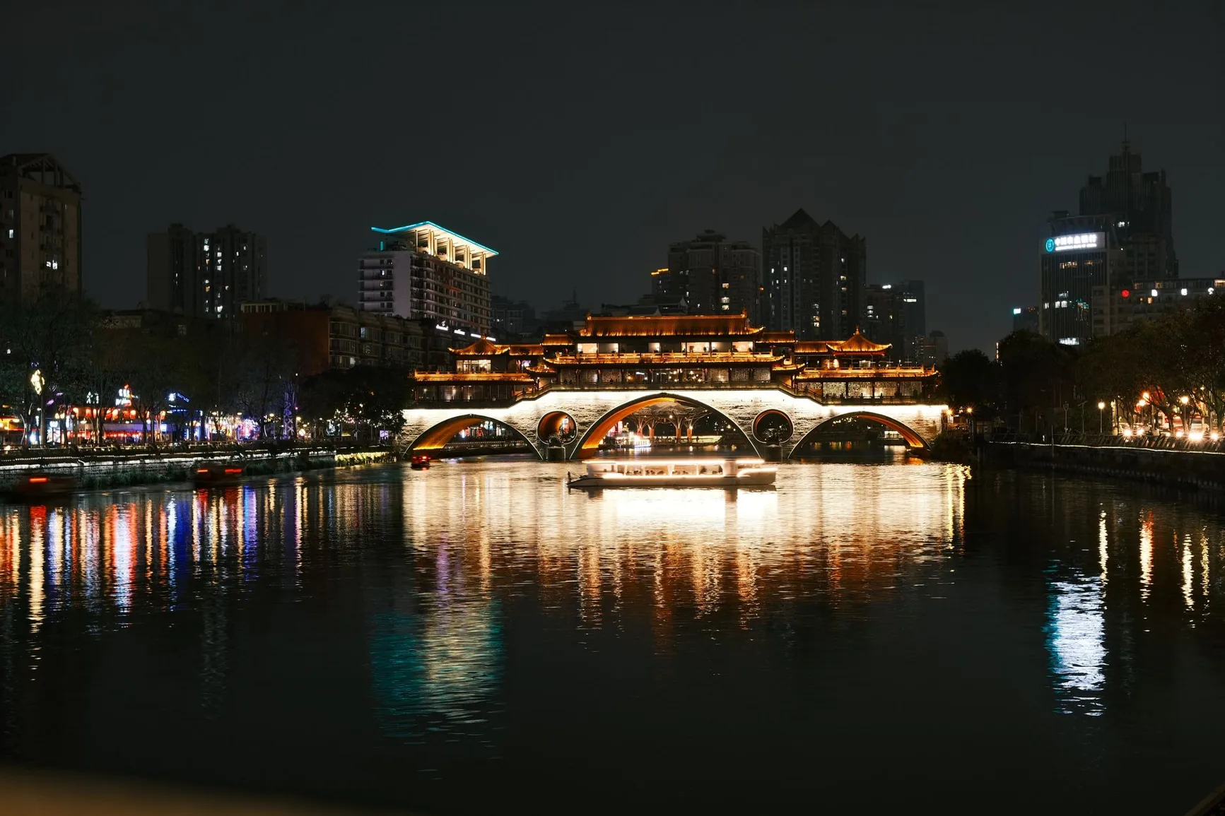 Anshun Bridge and its golden reflections on Chengdu’s river at night