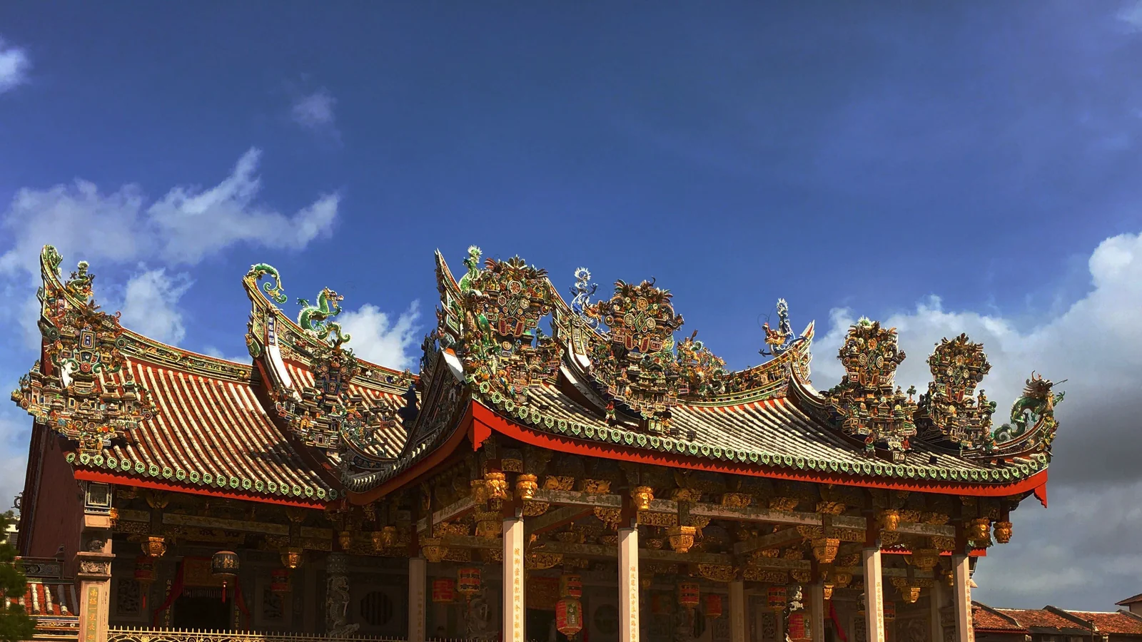 The ornate ceramic roof ridges and carved facade of Leong San Tong Khoo Kongsi in George Town.