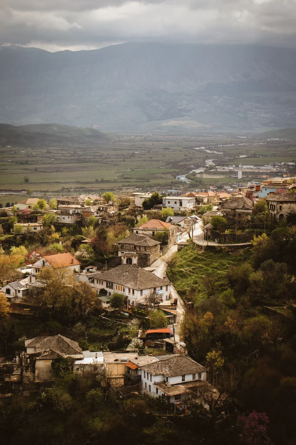 Gjirokastër hillside houses and stone roofs descending towards the Drinos valley
