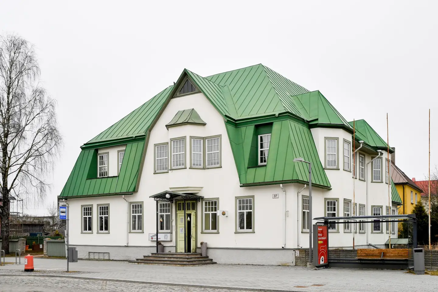 The white building with a green roof at Posti 37 in Haapsalu, beside the Veetorn bus stop