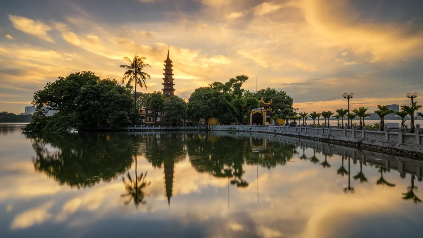 Tran Quoc Pagoda beside West Lake at sunset in Hanoi.