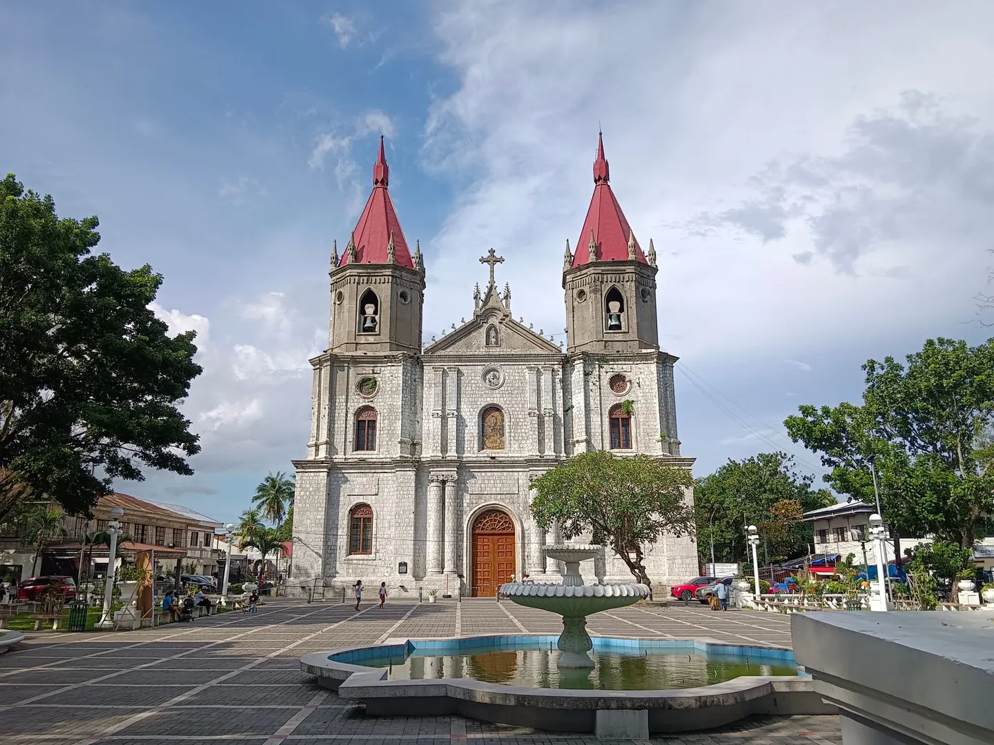 Molo Church’s twin red spires above the fountain in Molo Plaza, Iloilo City