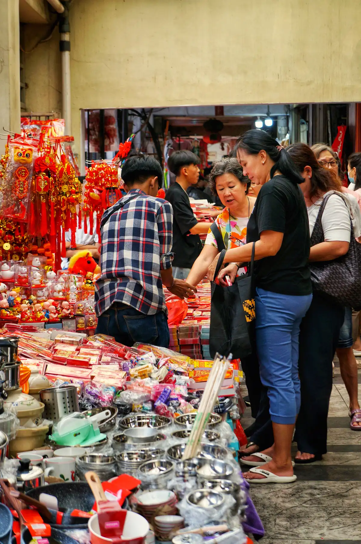 Shoppers browse goods at a busy market in Jakarta’s Chinatown