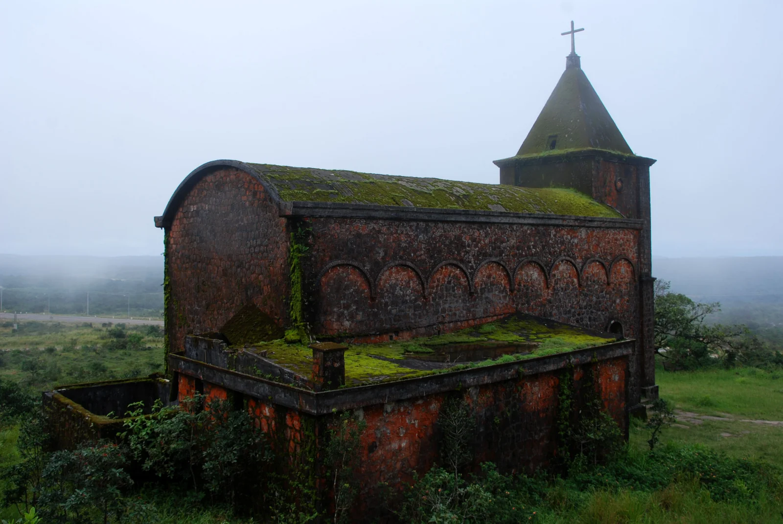 The moss-covered stone Catholic church on Bokor plateau above Kampot.