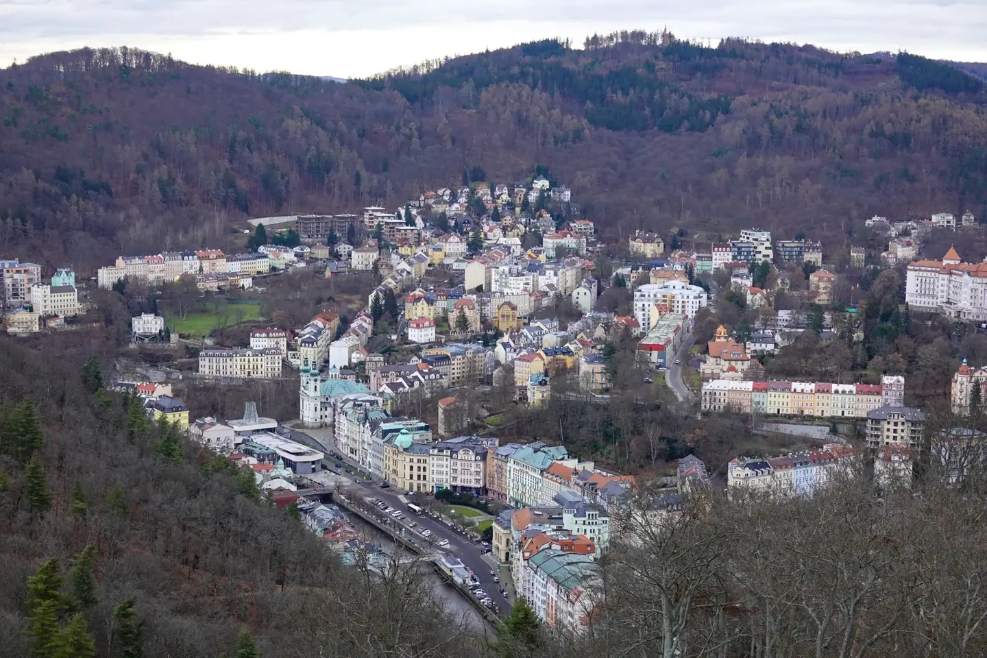 Karlovy Vary’s spa buildings and wooded valley seen from above
