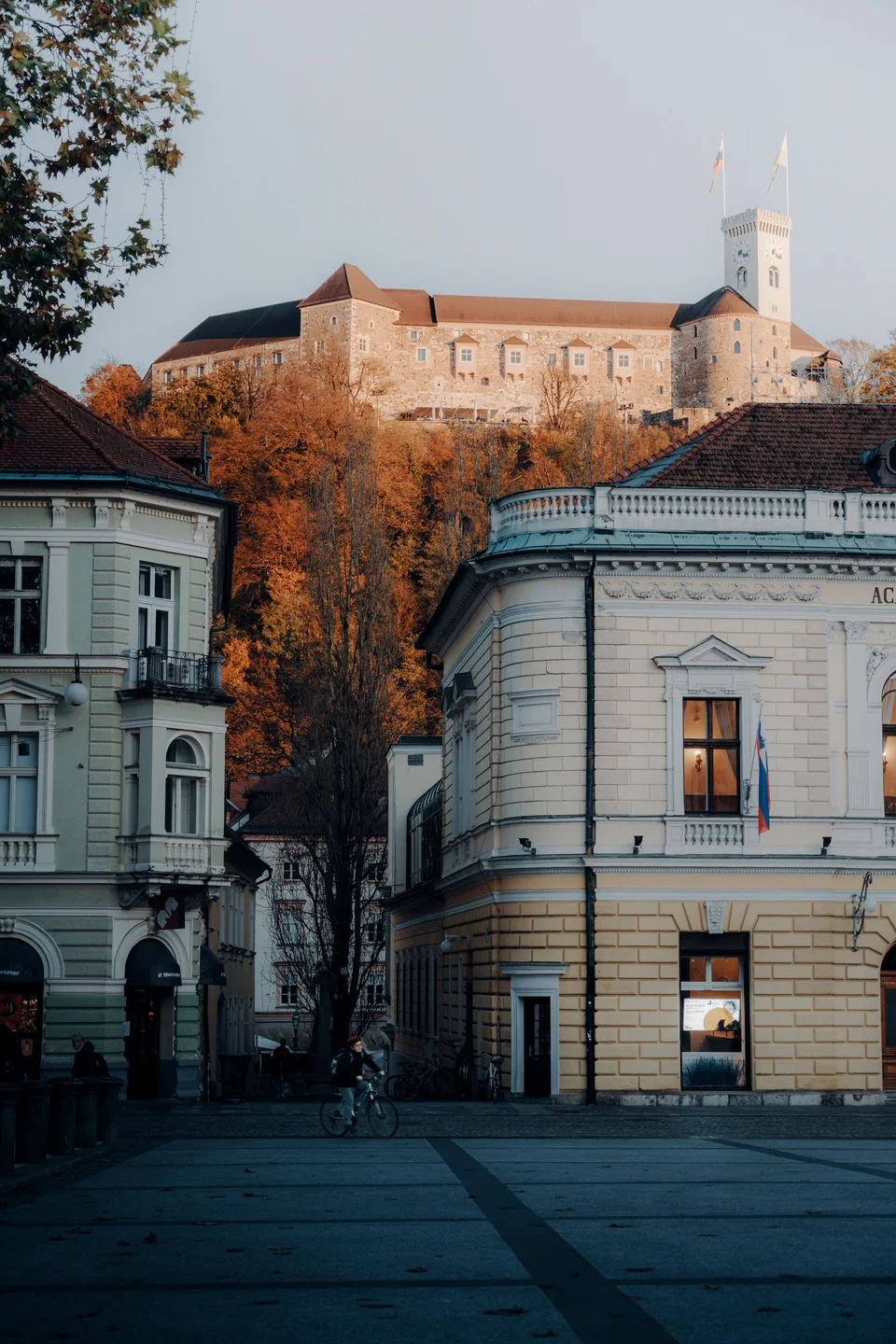 Ljubljana Castle above autumn trees and the buildings below Castle Hill