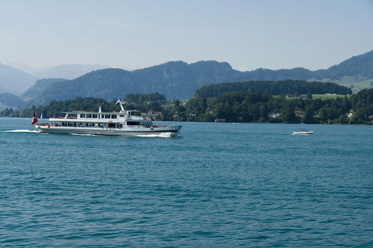 The SGV motor vessel Flüelen travelling across Lake Lucerne beneath wooded hills