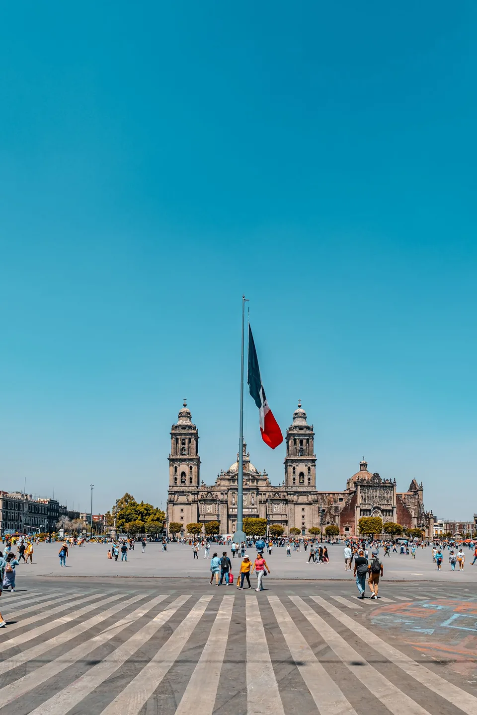 Mexican flag in the Zócalo in front of Mexico City Metropolitan Cathedral