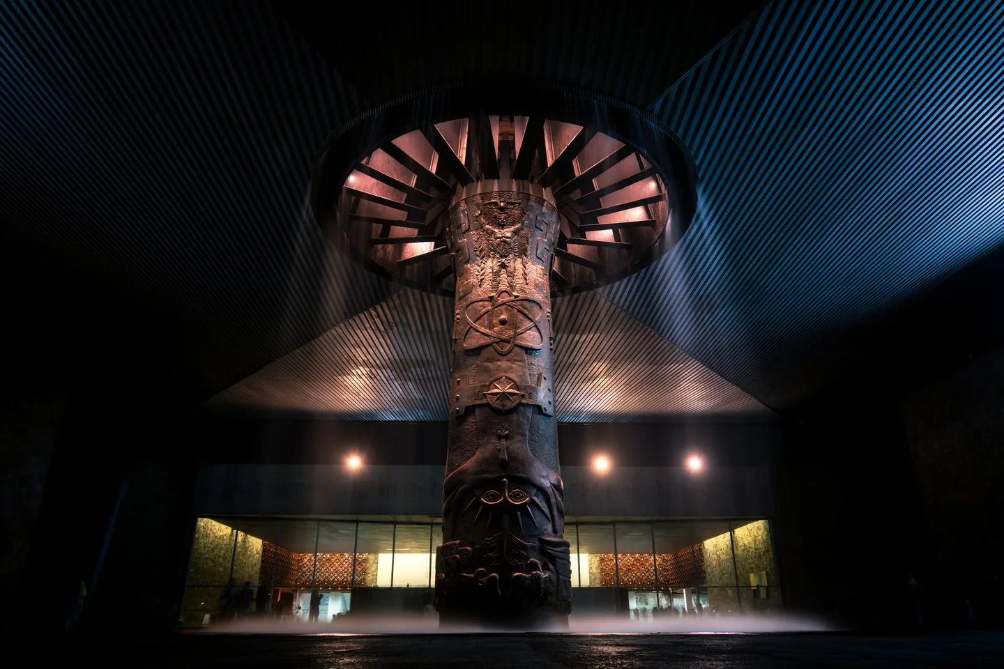 Illuminated carved column supporting El Paraguas in Mexico City’s National Museum of Anthropology