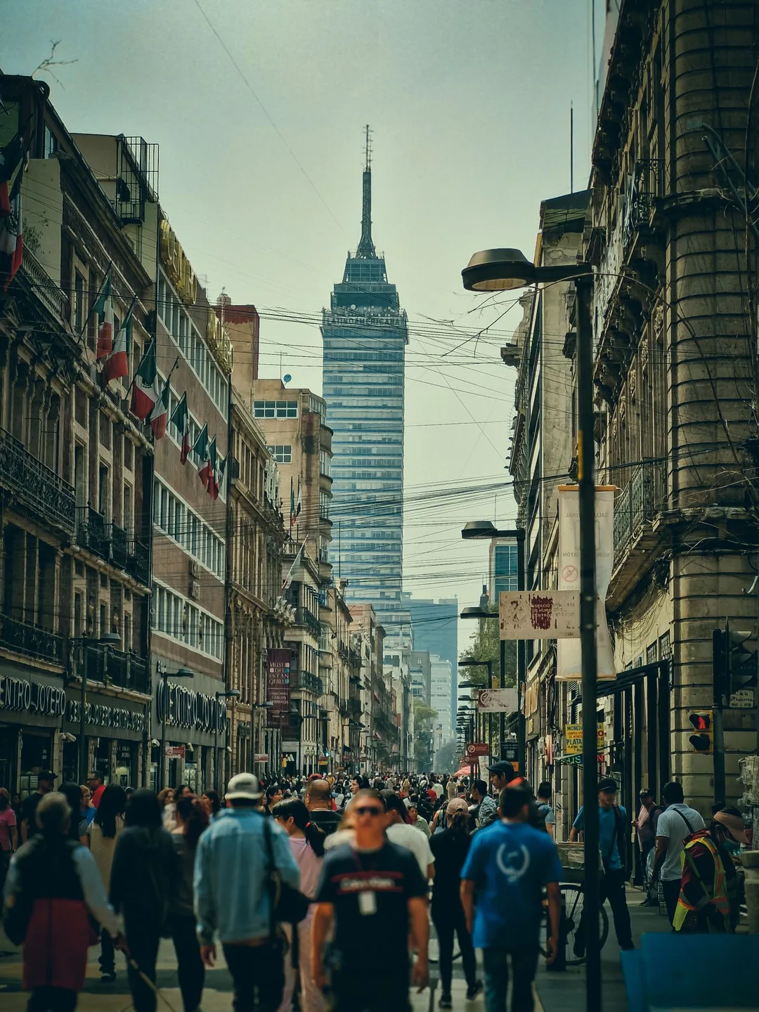 Pedestrians on Francisco I. Madero street with Torre Latinoamericana ahead in Mexico City