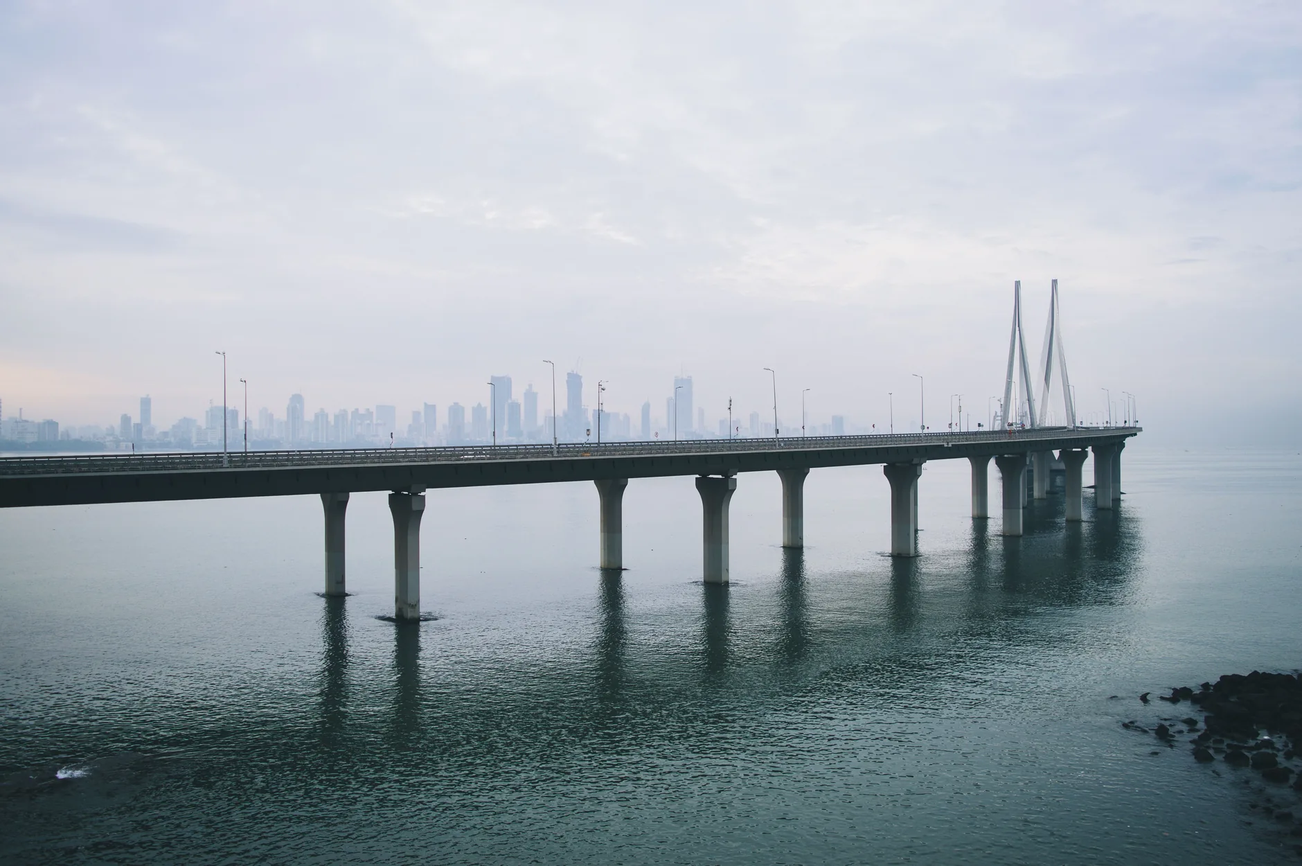 The Bandra–Worli Sea Link stretching across Mumbai Harbour under a cloudy sky