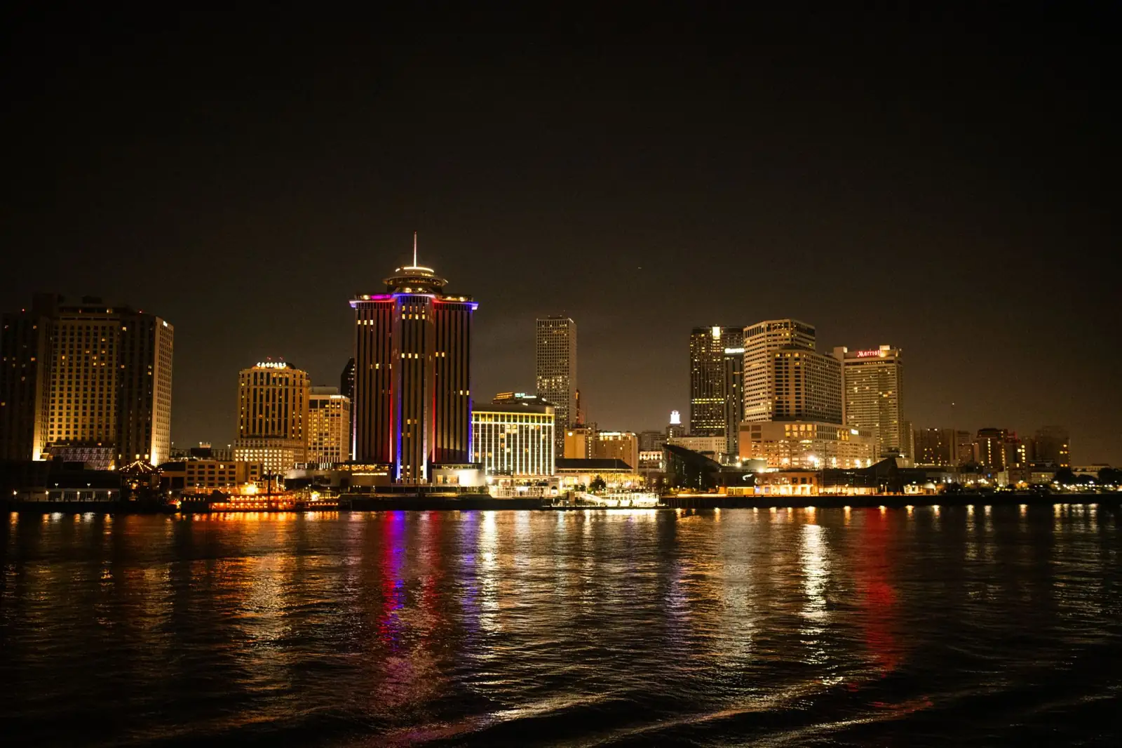 New Orleans downtown towers and riverfront lights reflected in the Mississippi