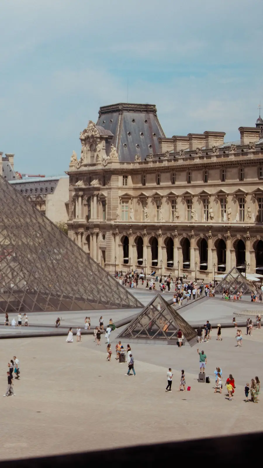 The Louvre pyramid and museum façades in Paris