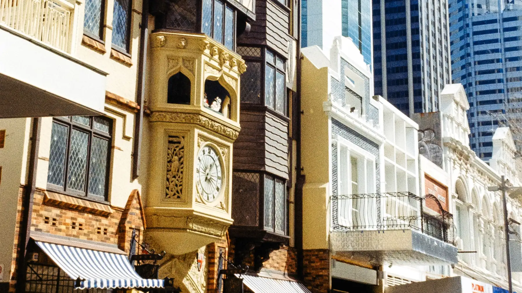 London Court’s mock Tudor frontage and gold clock beside modern Perth towers