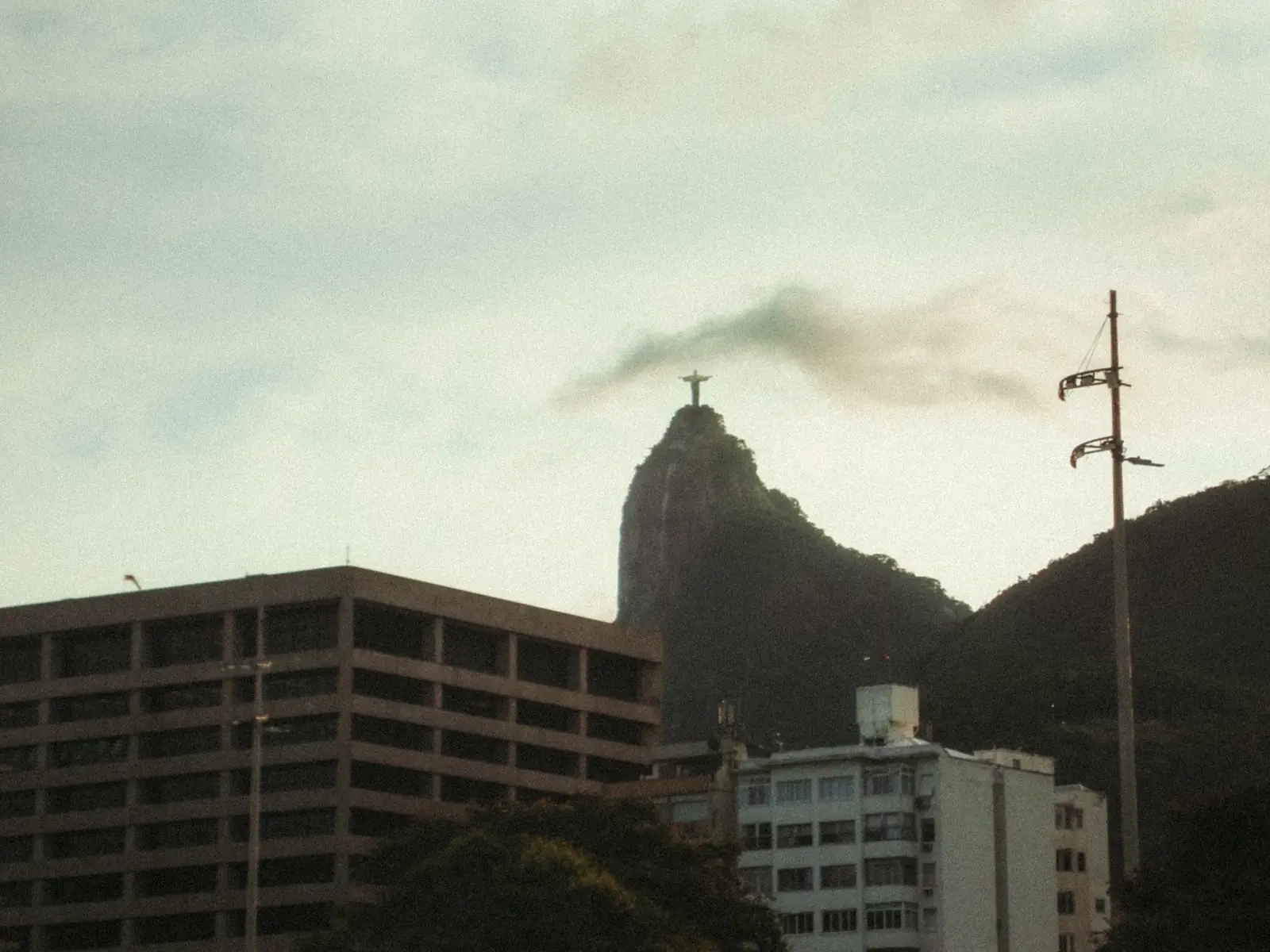 Christ the Redeemer above Corcovado with Rio buildings in the foreground