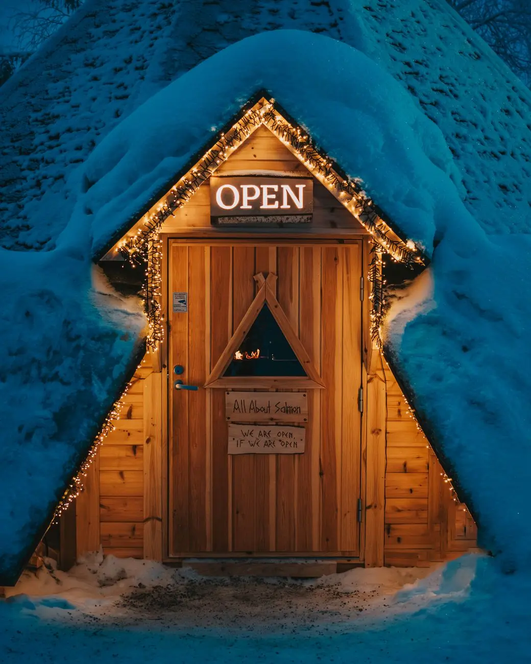 The wooden entrance to All About Salmon in Santa Claus Village, with its name visible on the door
