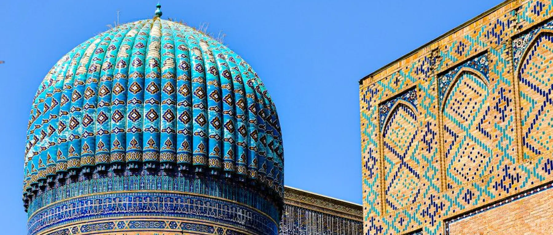 The ribbed turquoise dome and patterned portal of Bibi-Khanym Mosque in Samarkand