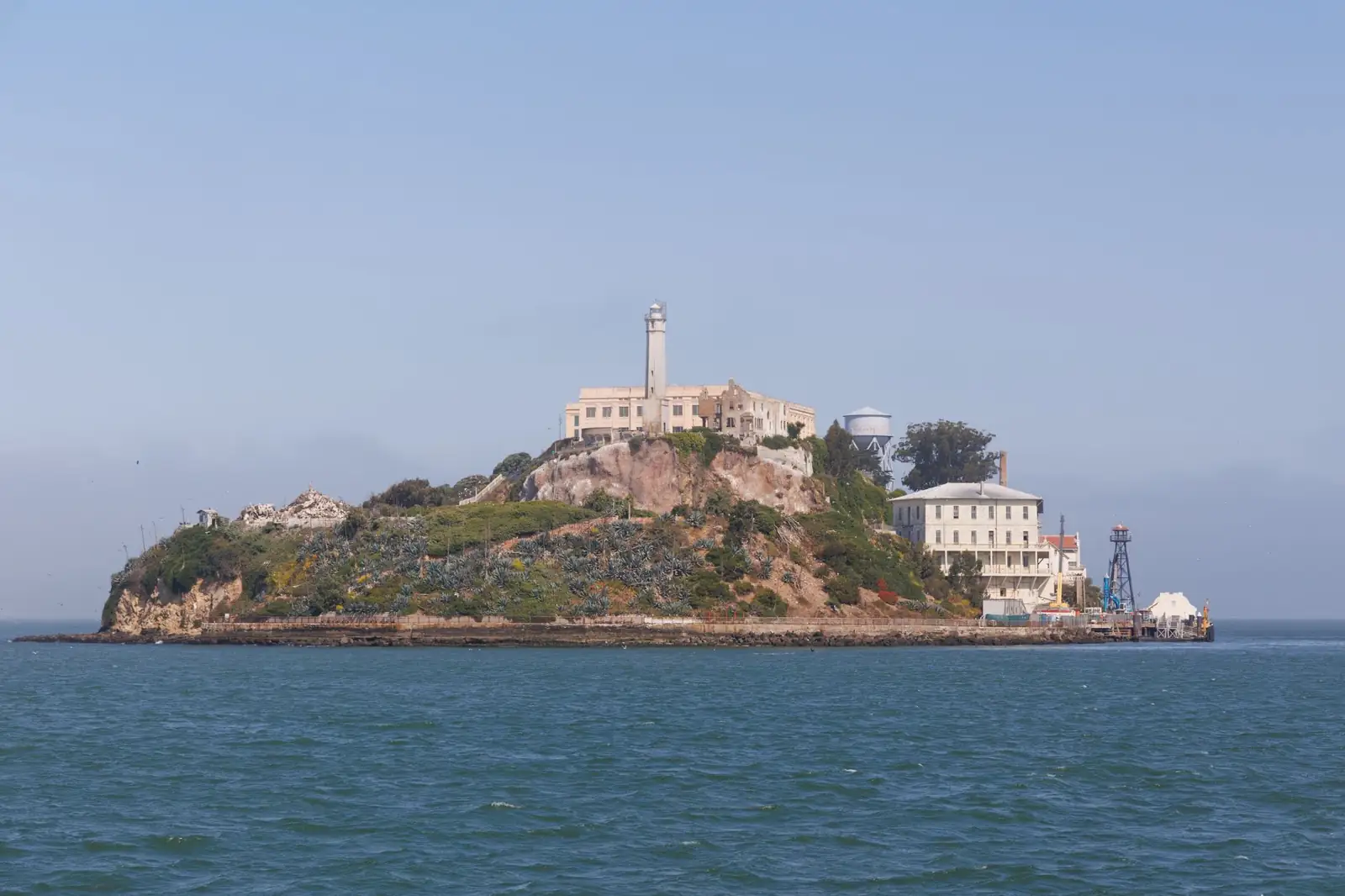 Alcatraz Island’s lighthouse, former prison, water tower and ferry landing in San Francisco Bay