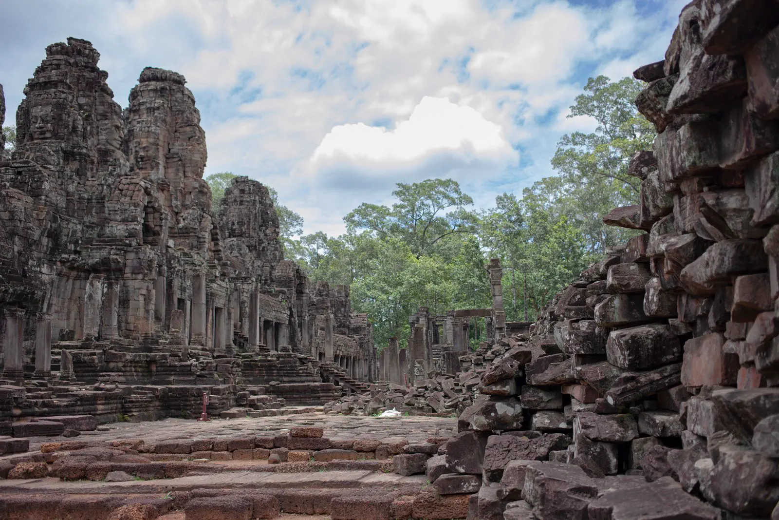Carved stone face towers rise above Bayon temple within Angkor Thom.