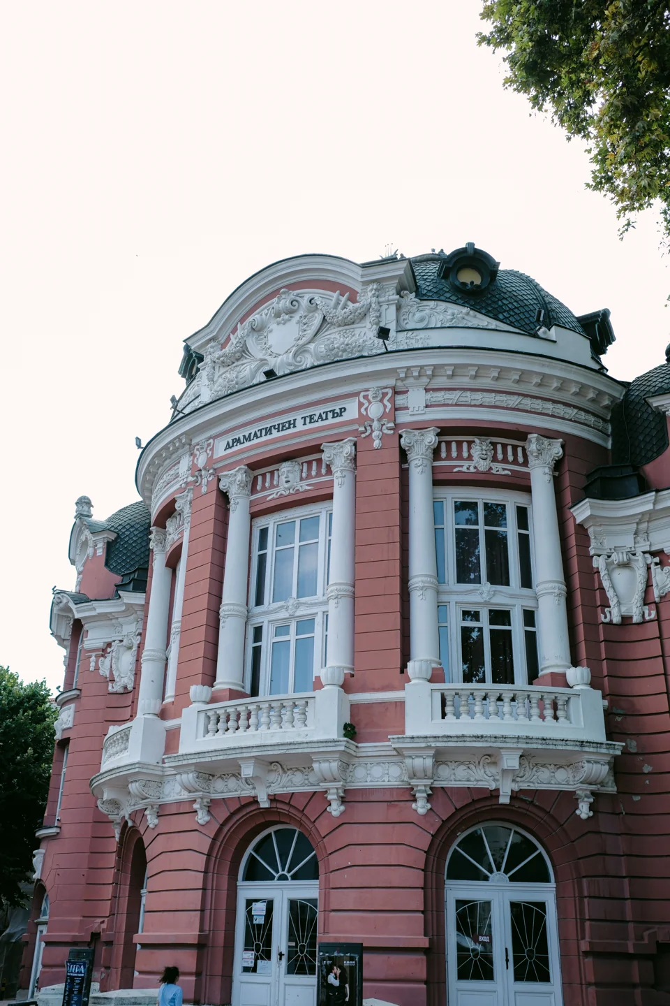 Curved pink façade and tall windows of Varna’s Stoyan Bachvarov Drama Theatre