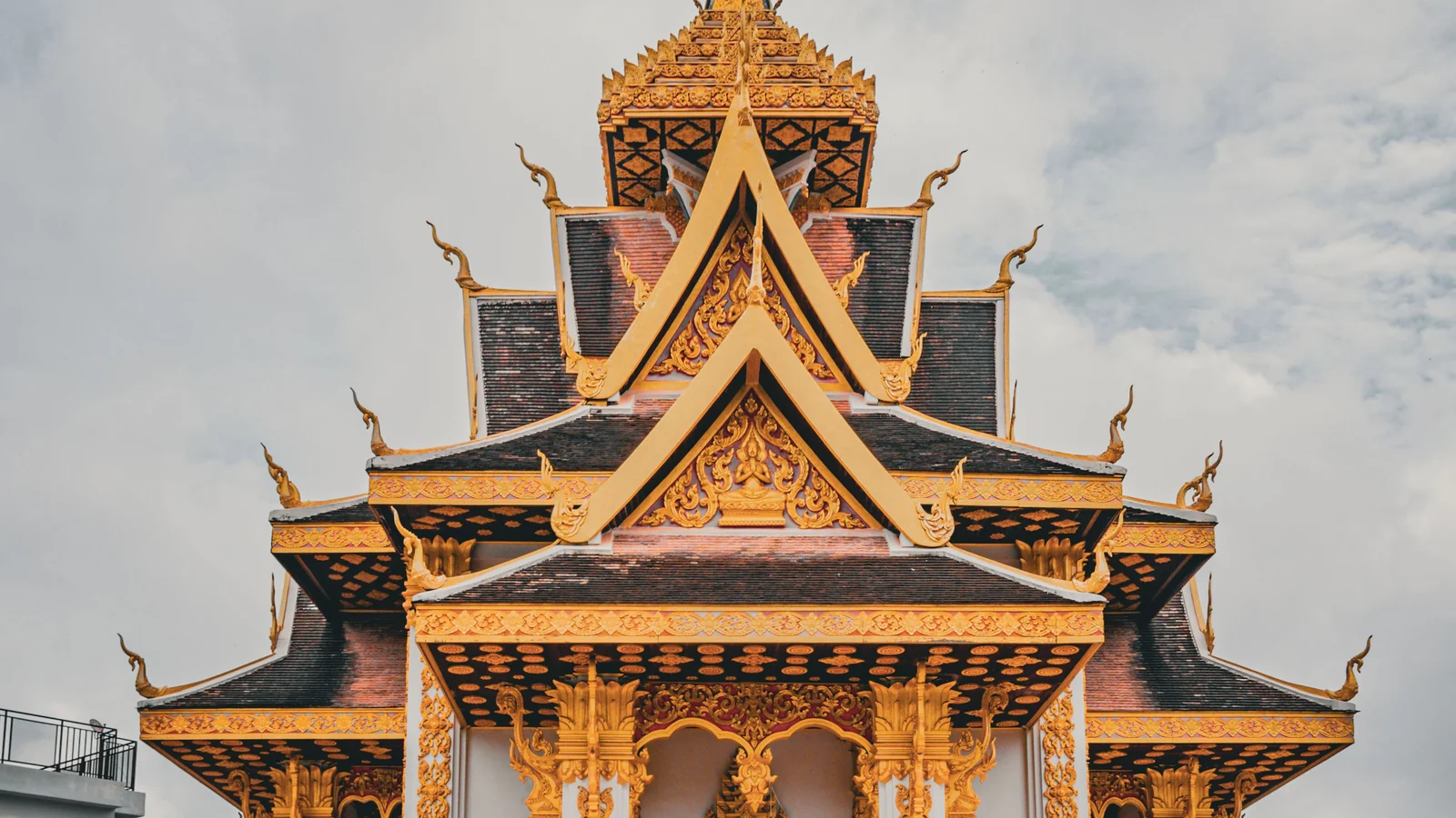 Layered gilded roofs and carved gables of Vientiane’s Hor Lak Muang city pillar shrine.