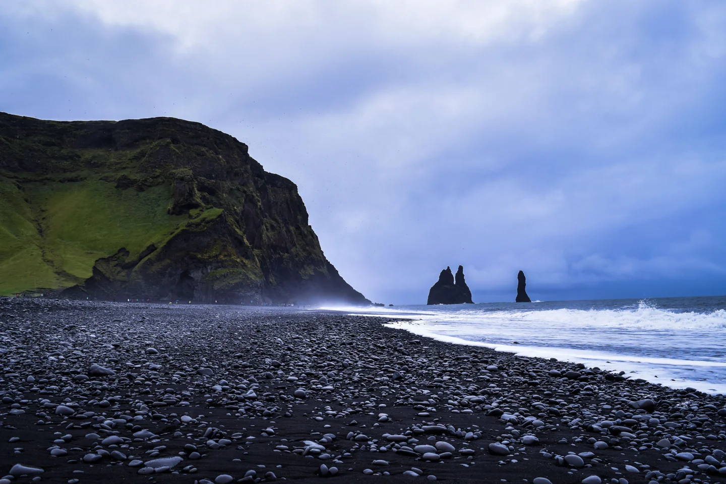 Reynisfjara’s black shoreline and Reynisdrangar sea stacks; the image does not indicate current permitted access