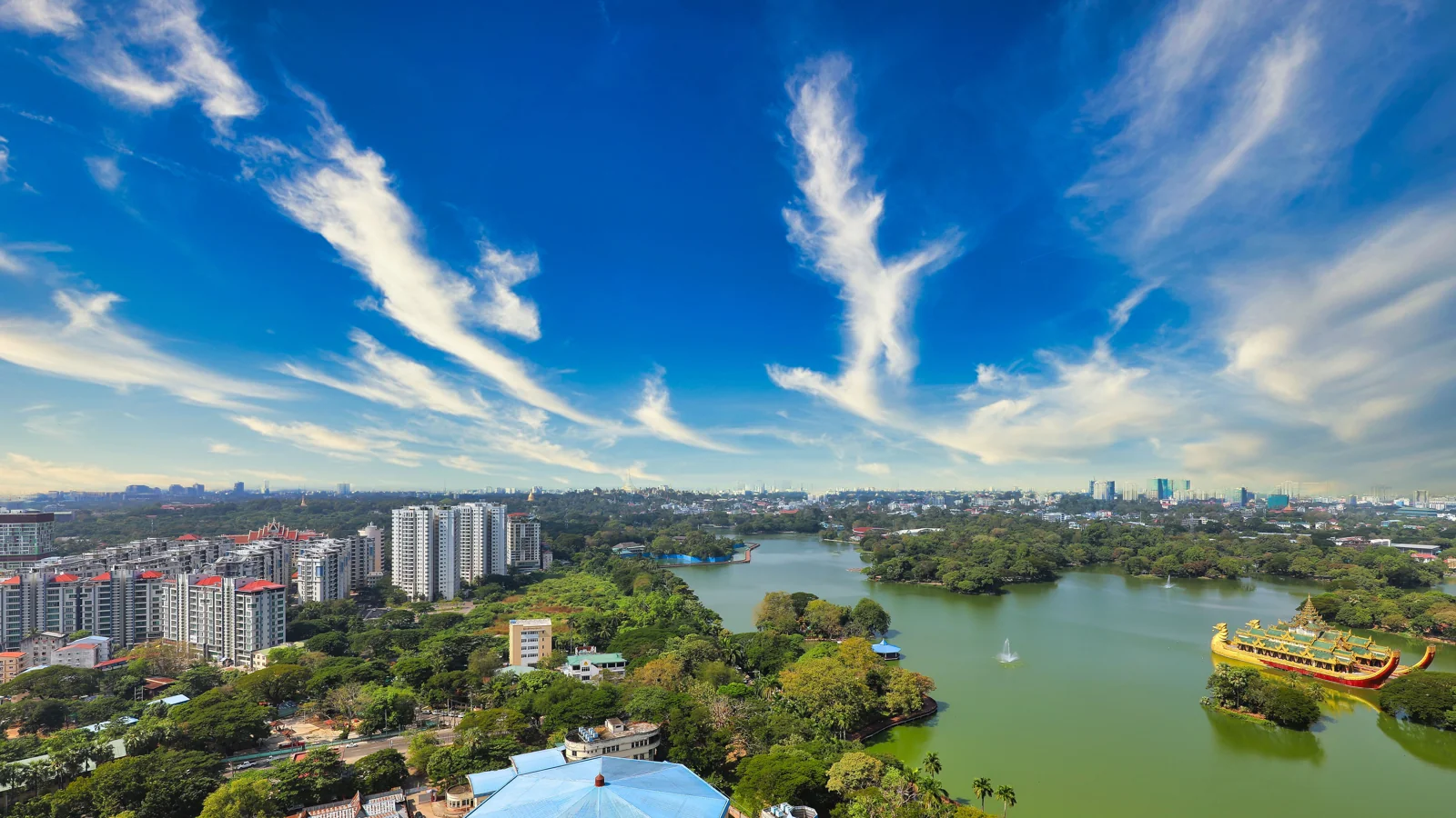 Kandawgyi Lake in Yangon, with Karaweik’s golden barge-shaped hall on the eastern shore.