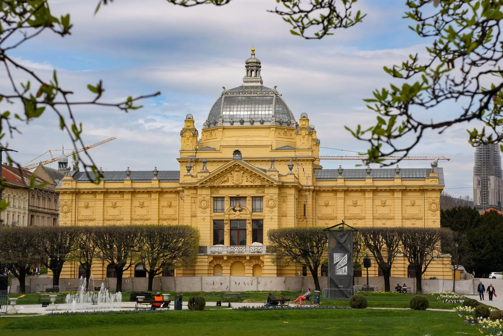 Zagreb’s yellow Art Pavilion behind the trees of King Tomislav Square