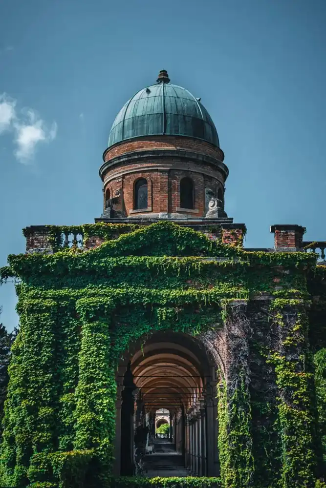 Ivy-covered brick arcade and green dome at Mirogoj Cemetery in Zagreb