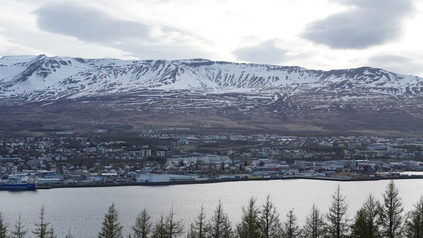 Akureyri across Eyjafjörður beneath snow-covered mountain slopes