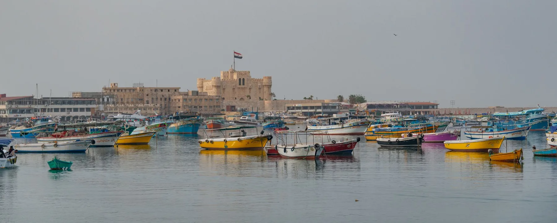 Fishing boats in Alexandria’s Eastern Harbour with Qaitbay Citadel behind