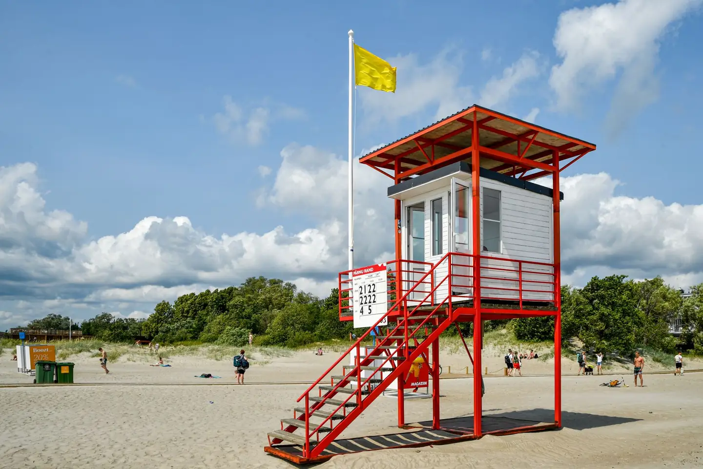 Pärnu Beach’s red-framed lifeguard tower above the sand beneath a blue sky