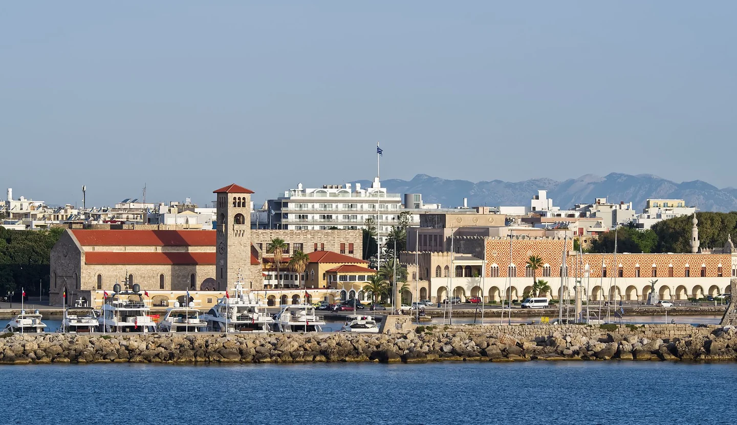 Mandraki harbour waterfront buildings and boats in Rhodes