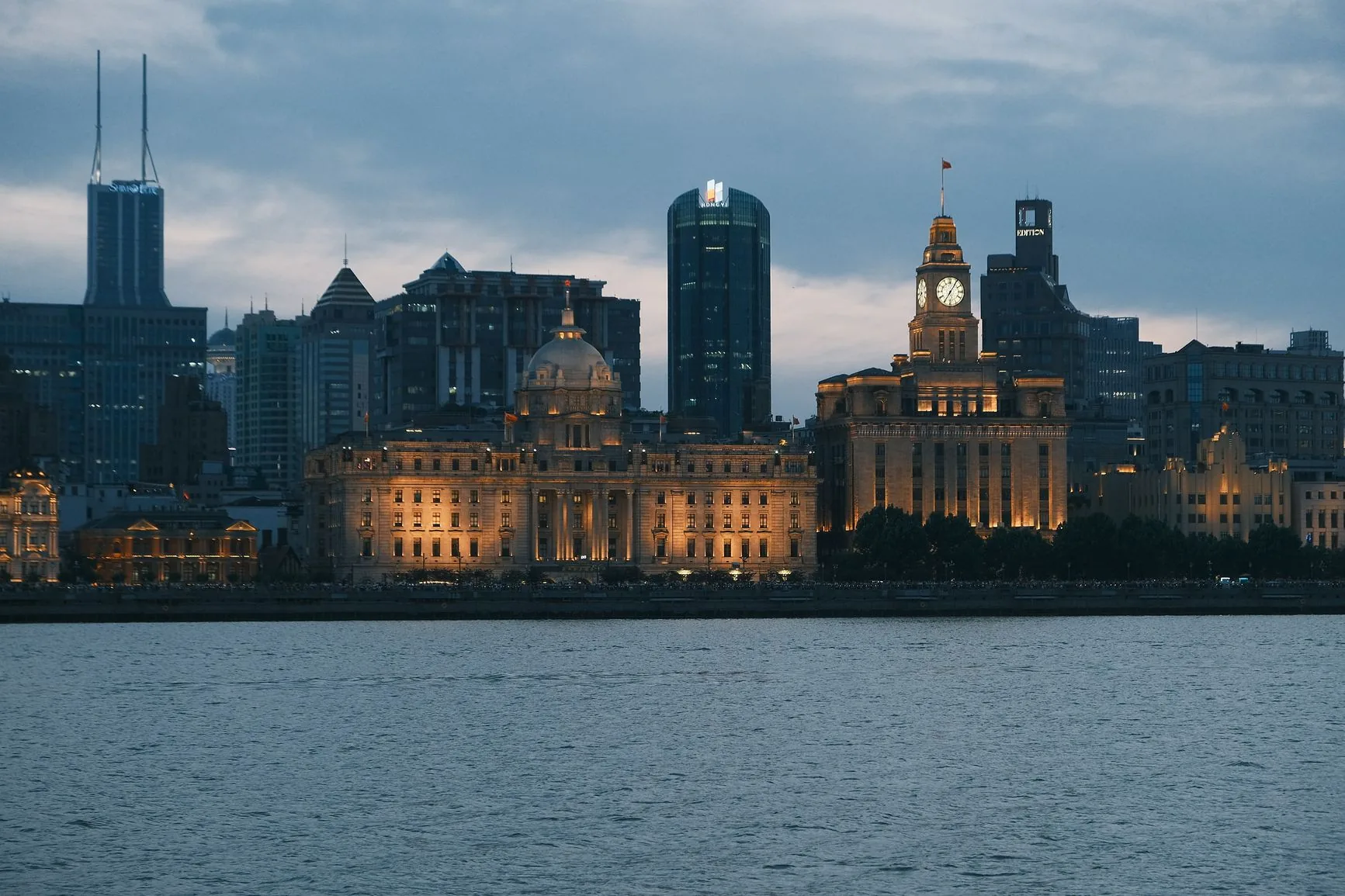 Shanghai’s Bund waterfront at twilight, with the domed former HSBC building and Customs House clock tower