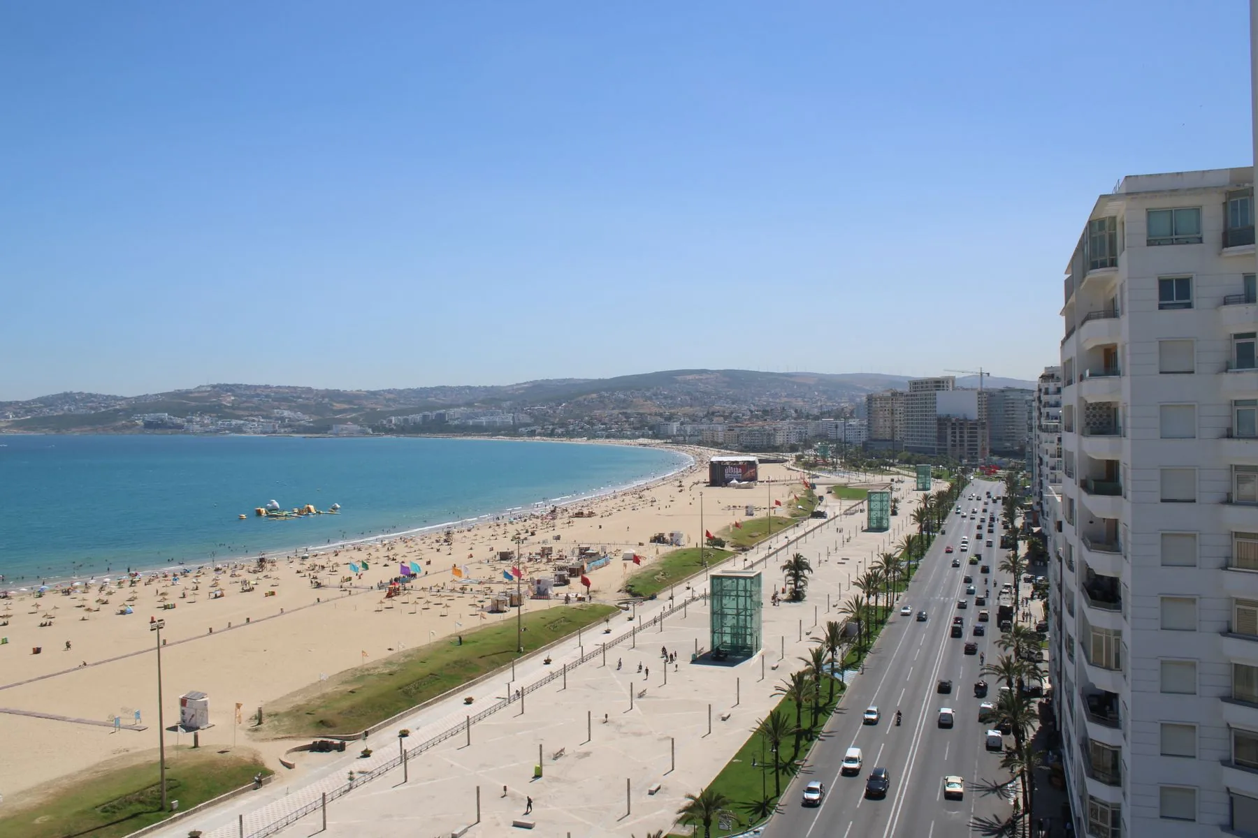 Tangier bay, city beach and palm-lined corniche curving towards Malabata