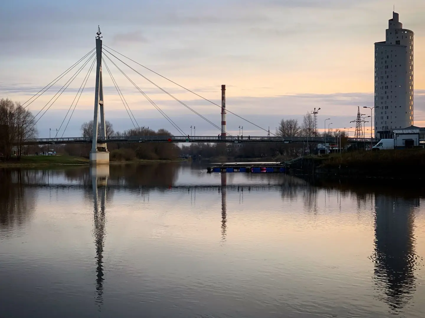Tartu’s cable-stayed Turusild pedestrian bridge and Tigutorn reflected in the Emajõgi at twilight