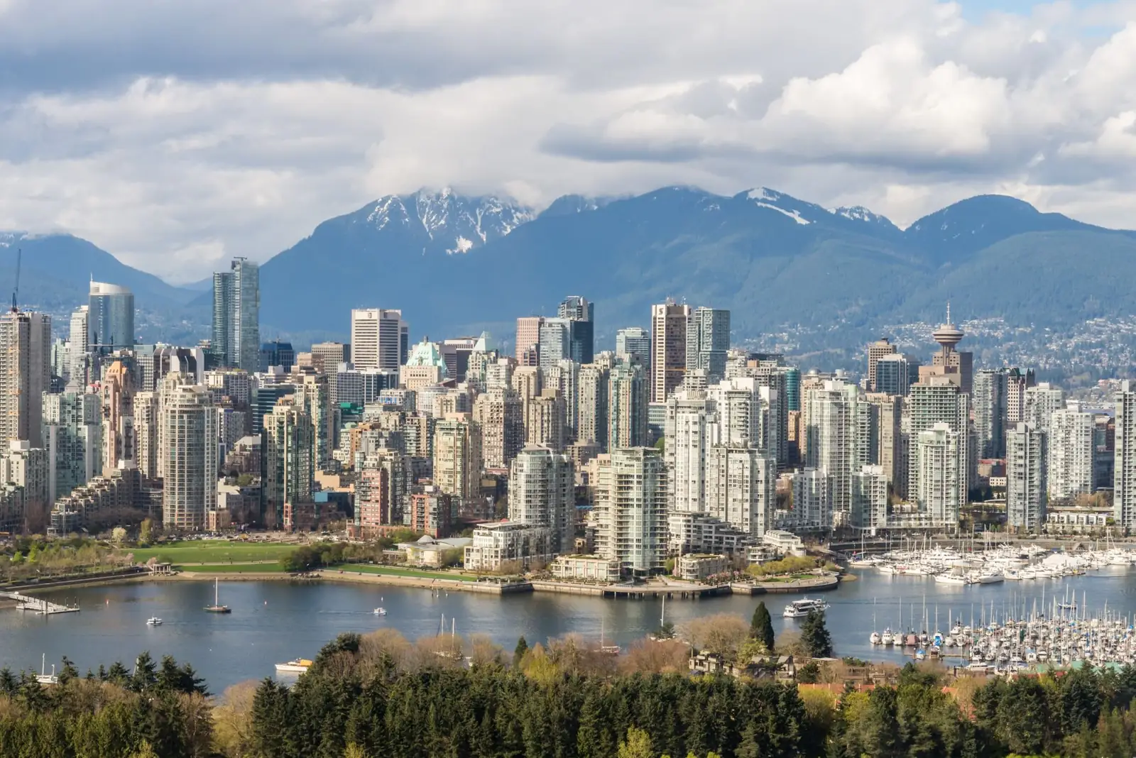 Vancouver waterfront towers and a marina backed by the North Shore mountains