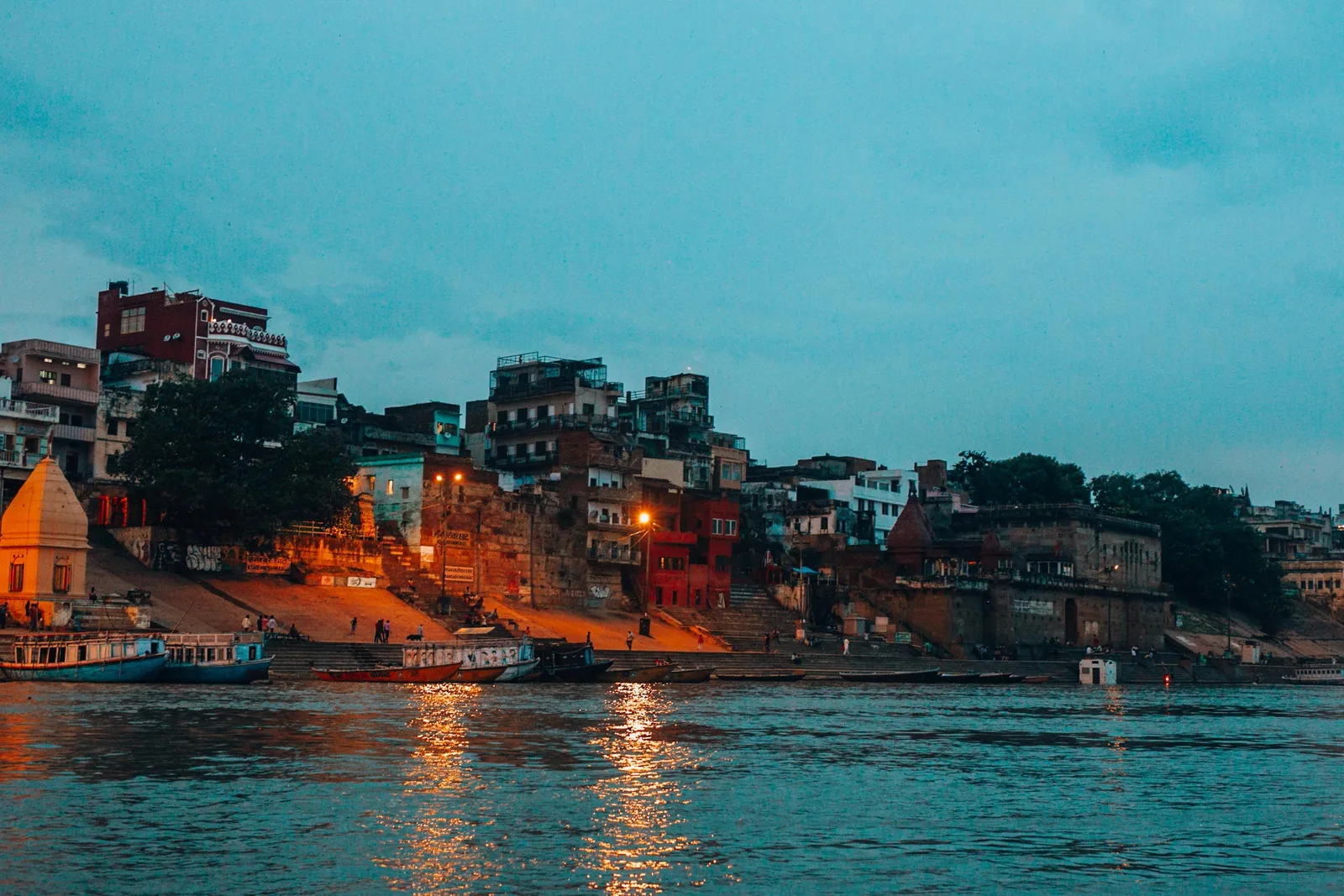Ganges riverfront ghats and boats at dusk in Varanasi