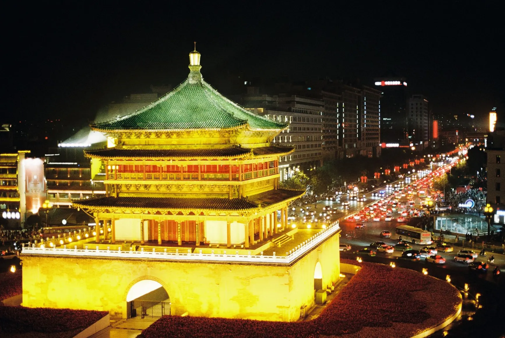 Xi’an’s illuminated Bell Tower surrounded by city streets at night